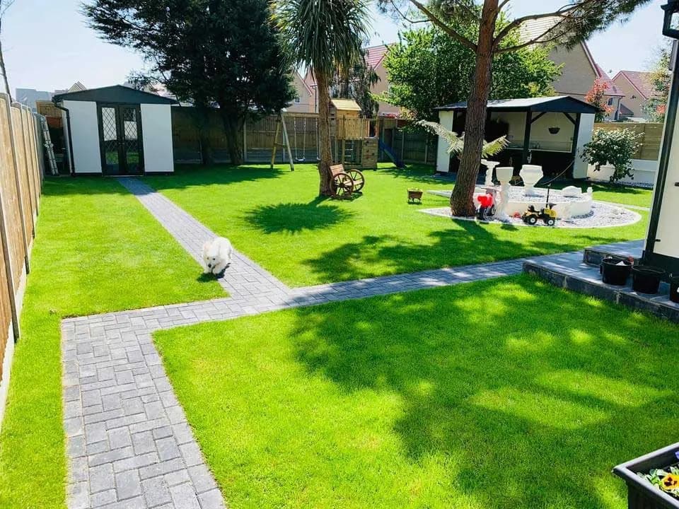 Block paved pathway laid through a landscaped garden